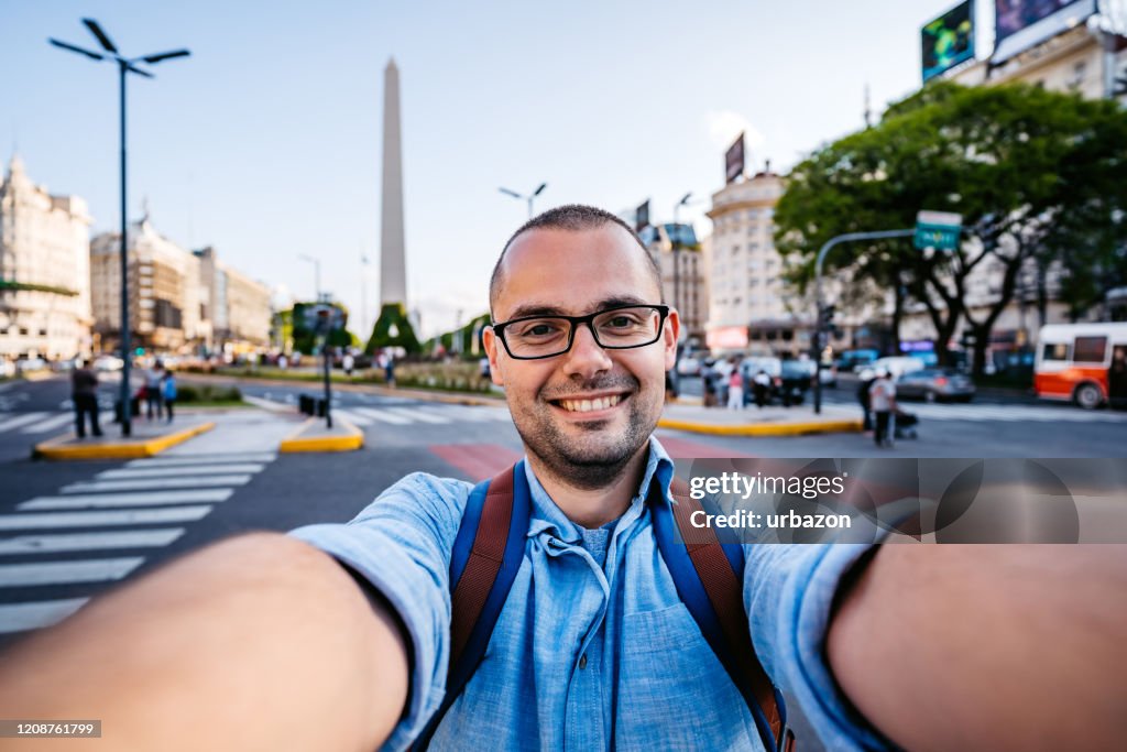 Man making selfie with obelisco of Buenos Aires
