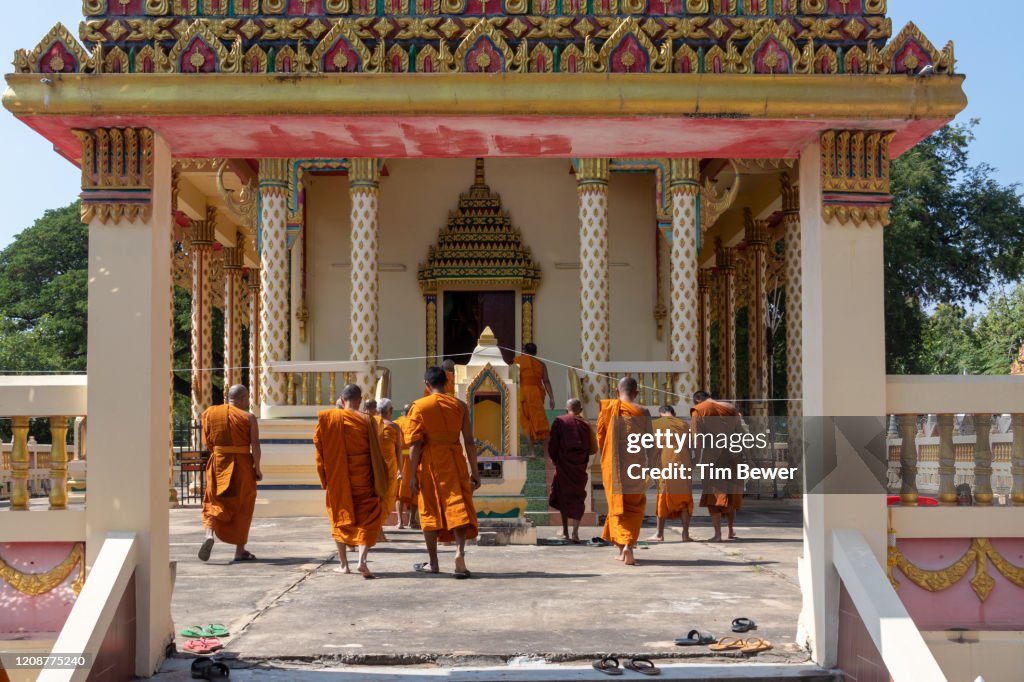Buddhist monks entering ubosot before confessional meeting.