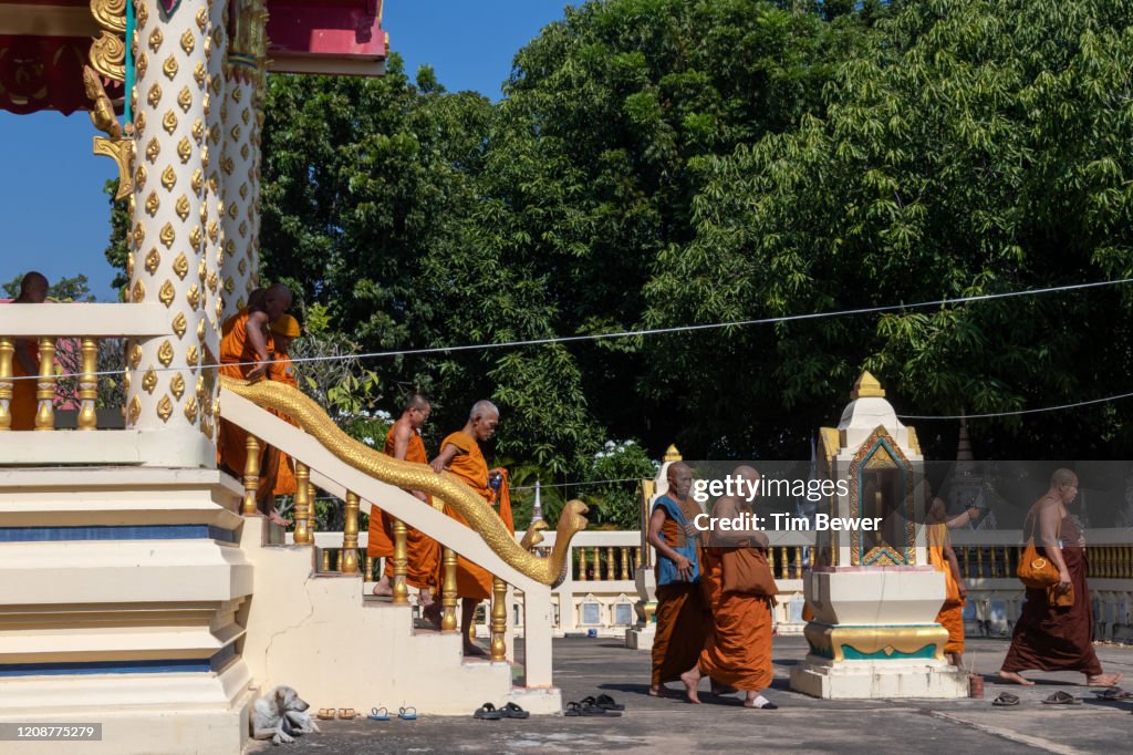 Buddhist monks leaving ubosot after confessional meeting.