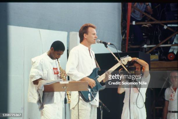 Sting, Branford Marsalis, being filmed by TV cameraman Live Aid, 13 July 1985 Wembley Stadium, London.