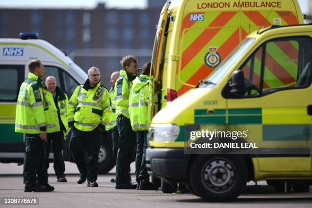 London Ambulance staff members are seen in the car park at the ExCeL London exhibition centre in London on April 1 which has been transformed into...