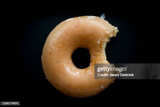 doughnut bite - eaten foto e immagini stock