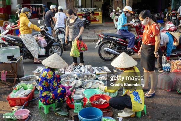 Fishmonger prepares an order at Hoa Binh market during a partial lockdown imposed due to the coronavirus in Ho Chi Minh City, Vietnam, on Wednesday,...