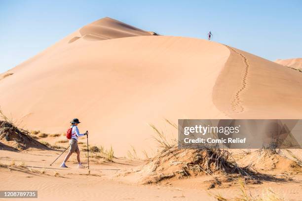 Louise Minchin walks across the sand on Day 2 of the Sport Relief challenge: The Heat is On, as the team sets off on February 25, 2020 in the Namib...