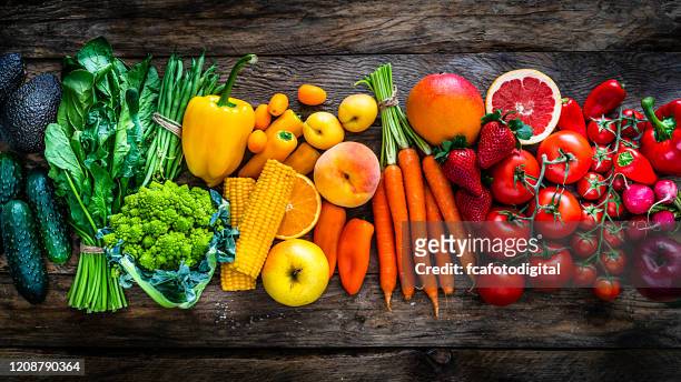 healthy fresh rainbow colored fruits and vegetables in a row - leaf vegetable stock pictures, royalty-free photos & images