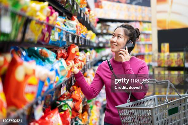 asian female shopping in supermarket - asian woman shopping grocery stock pictures, royalty-free photos & images