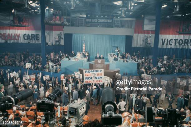High angle view showing Republican Party members wearing straw boaters and carrying placards and banners in support of Governor George Romney at the...