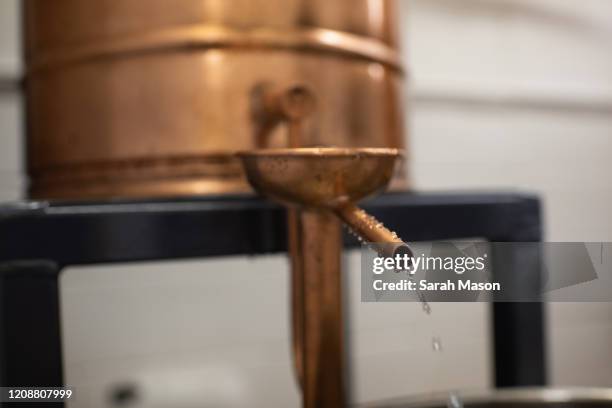 gin coming out of a copper gin still - distillery still stock pictures, royalty-free photos & images