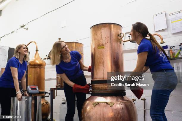 three women working in gin distillery - community spirit fotografías e imágenes de stock