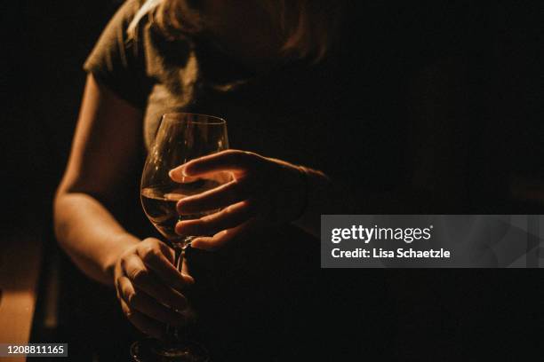 woman drinks wine at home - alcolismo foto e immagini stock