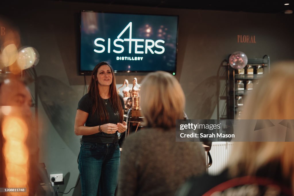 Woman giving talk in distillery
