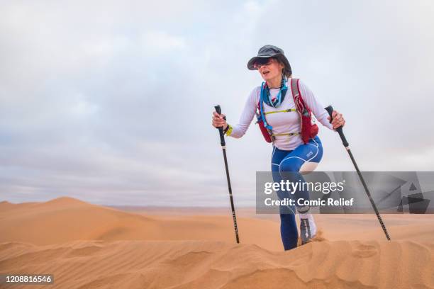 Louise Minchin walks across the sand on Day 3 of the Sport Relief challenge: The Heat is On, as the team sets off on February 26, 2020 in the Namib...