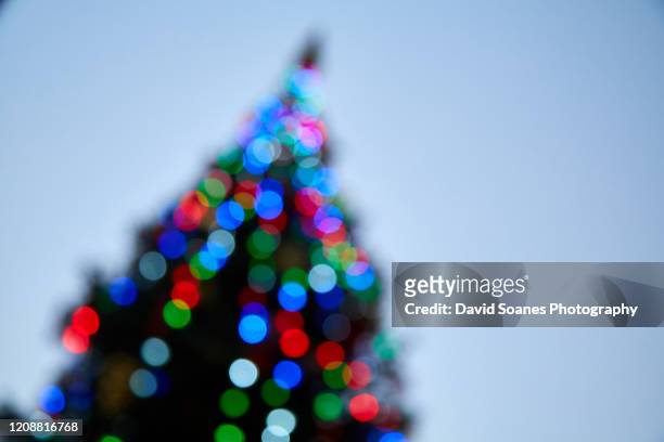 a blurred christmas tree on o'connell street, dublin city, ireland - 1916 2016 stock pictures, royalty-free photos & images