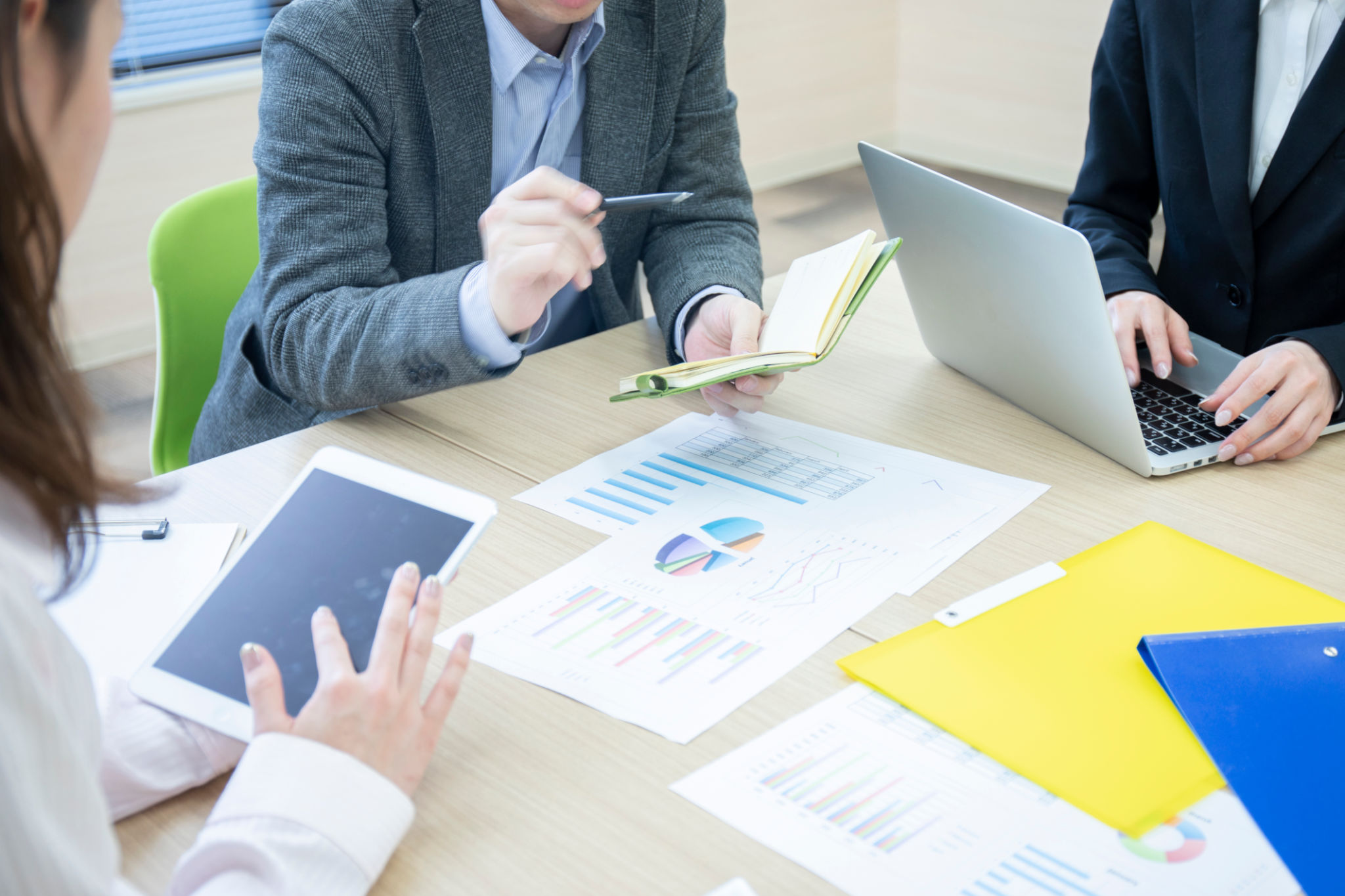 Hands of three men and women meeting in a meeting room Hands of three men and women meeting in a meeting room