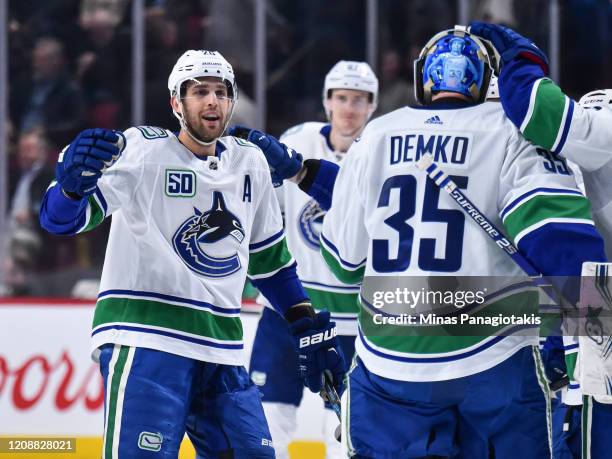 Brandon Sutter of the Vancouver Canucks celebrates an overtime victory with goaltender Thatcher Demko against the Montreal Canadiens at the Bell...