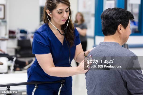 emergency room doctor checks a patient's lungs - triage stock pictures, royalty-free photos & images
