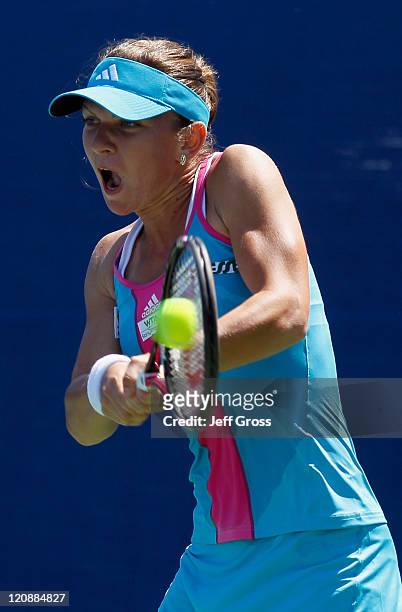 Simona Halep of Romania returns a backhand to Tamira Paszek of Austria during the Mercury Insurance Open presented by Tri-City Medical at the La...