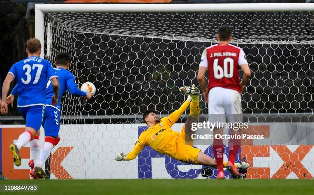 Matheus Magalhaes of Braga saves a penalty from Ianis Hagi of Rangers FC during the UEFA Europa League round of 32 second leg match between Sporting...