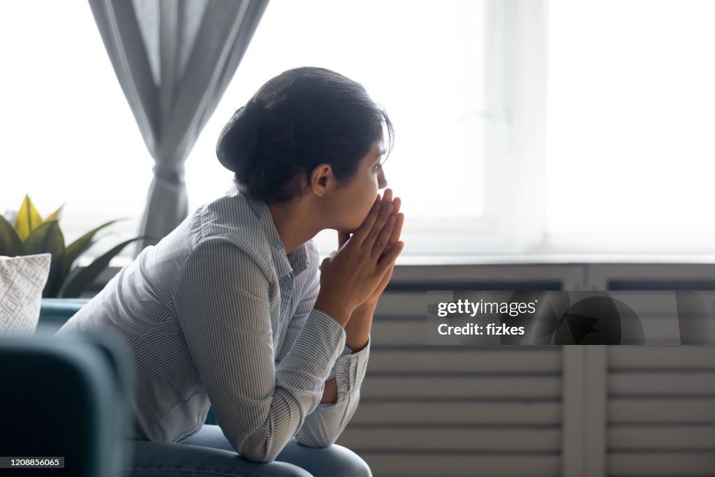 Pensive indian girl lost in thoughts suffering from depression