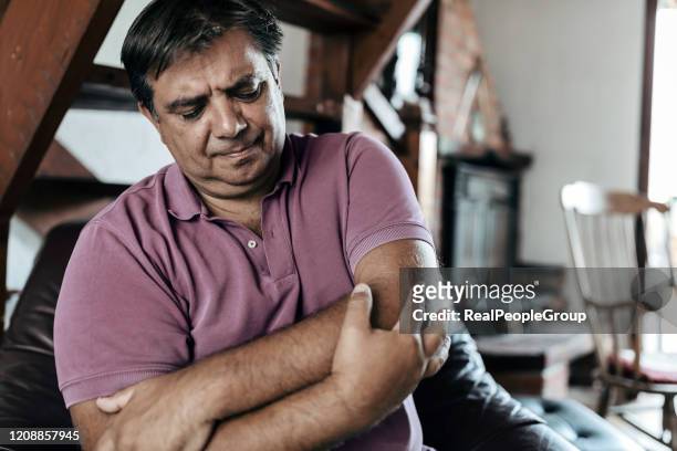 man elbow pain. man suffering from pain and rheumatism - muscle cramps stock pictures, royalty-free photos & images