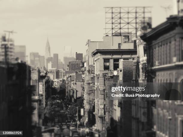 manipulated high-angle view of manhattan with the chrysler building far away in the horizon. new york city, usa - classic photos of the american skyscraper stock pictures, royalty-free photos & images