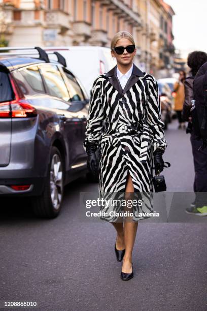 Caroline Daur, wearing a zebra print coat, black gloves, black heels and black Tod's bag is seen outside Tod's show, during Milan Fashion Week...