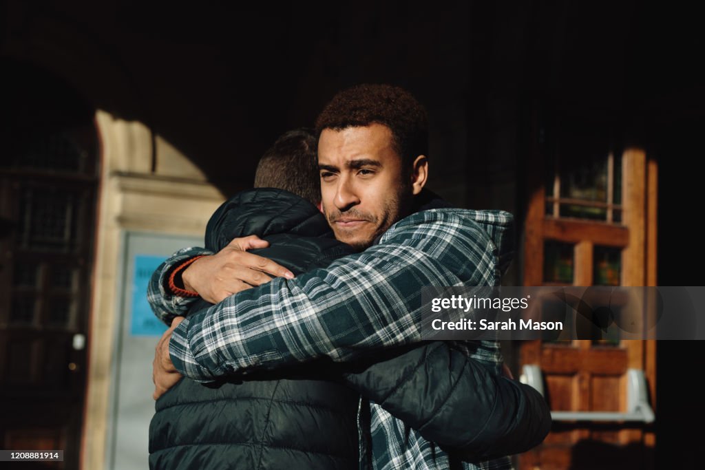 Two men hugging