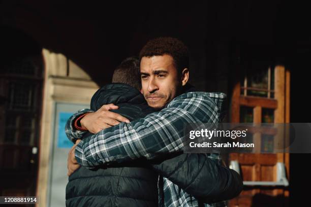 two men hugging - freundschaft männer stock-fotos und bilder