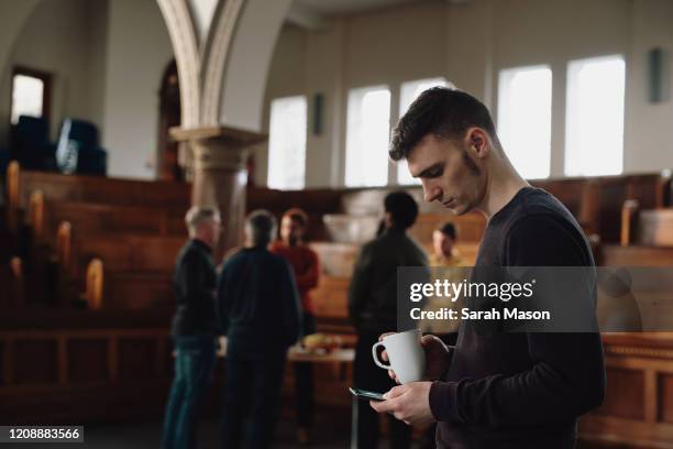 young man checks his phone - friends loneliness foto e immagini stock