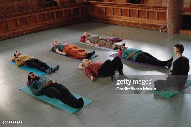 all male yoga class - savasana - spiritual enlightenment stock pictures, royalty-free photos & images