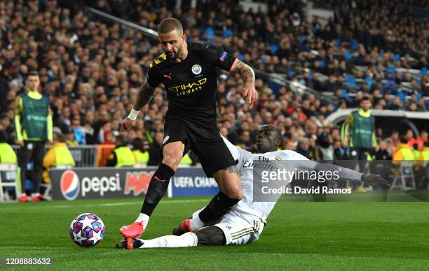 Ferland Mendy of Real Madrid tackles Kyle Walker of Manchester City during the UEFA Champions League round of 16 first leg match between Real Madrid...