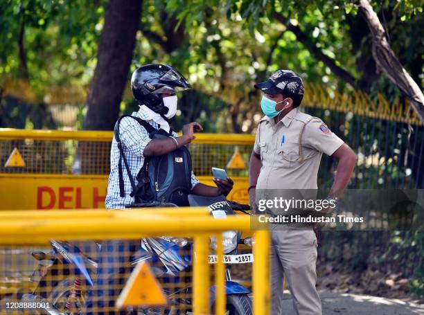 Delhi police check vehicles and commuters for valid papers and permits at a checkpoint, on day 8 of the 21 day nationwide lockdown imposed by PM...