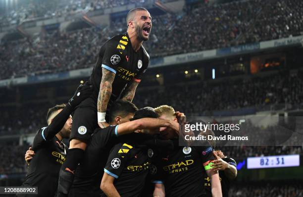 Kyle Walker of Manchester City joins in as Kevin De Bruyne of Manchester City celebrates with teammates after scoring his team's second goal during...