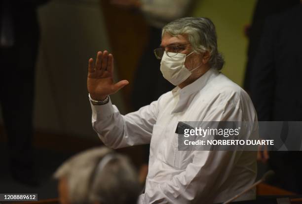 Paraguayan senator Fernando Lugo, of the Frente Guazu party, wears a face mask as he attends an extraordinary session to discuss measures to contain...