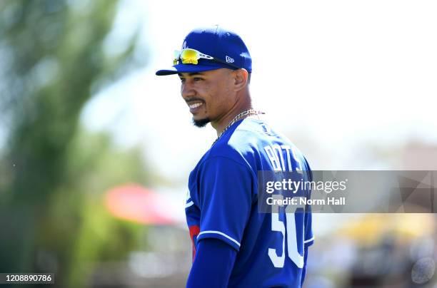 Mookie Betts of the Los Angeles Dodgers prepares for a spring training game against the Los Angeles Angels at Camelback Ranch on February 26, 2020 in...