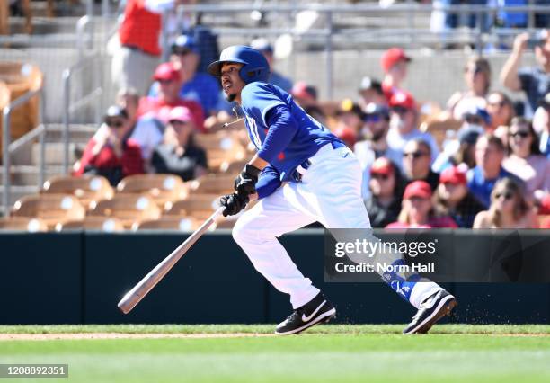 Mookie Betts of the Los Angeles Dodgers hits a fly ball out to left field of a spring training game against the Los Angeles Angels at Camelback Ranch...