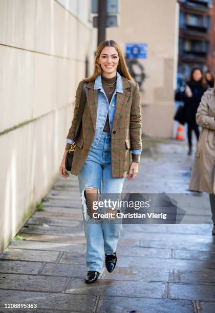 Sofia Sanchez de Betak seen wearing ripped denim jeans, jacket, khaki checkered blazer outside Kenzo during Paris Fashion Week - Womenswear...