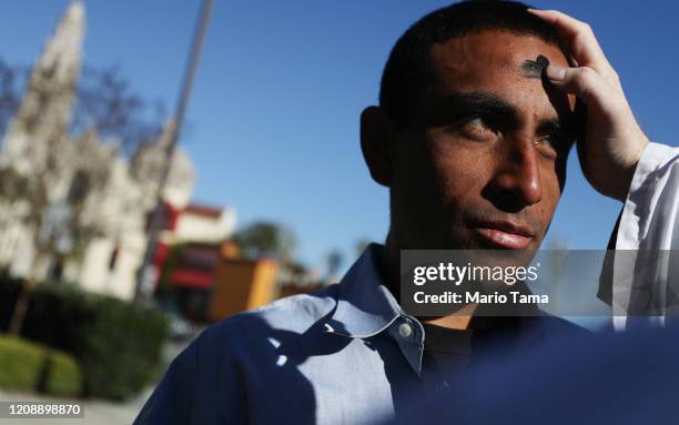 Ramon Mendez receives ashes in front of St. John's Episcopal Cathedral on Ash Wednesday on February 26, 2020 in Los Angeles, California. The deans of...