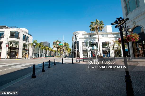 View of a deserted Rodeo Drive in Beverly Hills, California on April 1, 2020 during the Covid 19 crisis. - All 40 million residents of California...