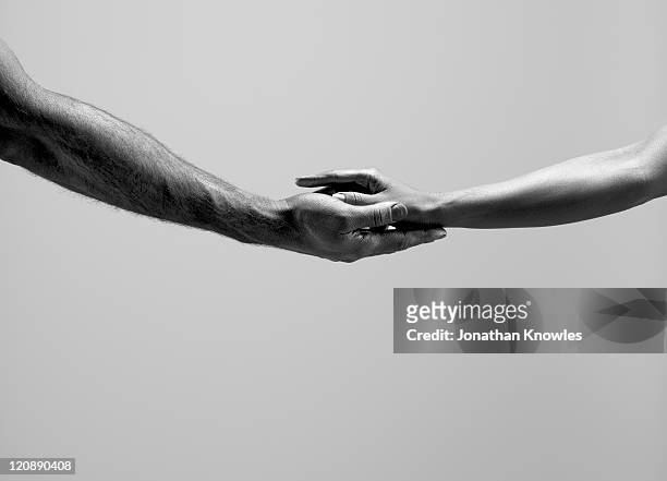 female and male hands - black and white holding hands stock pictures, royalty-free photos & images