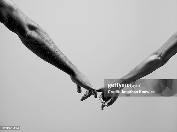 female and male connecting by fingers - two finger stockfoto's en -beelden