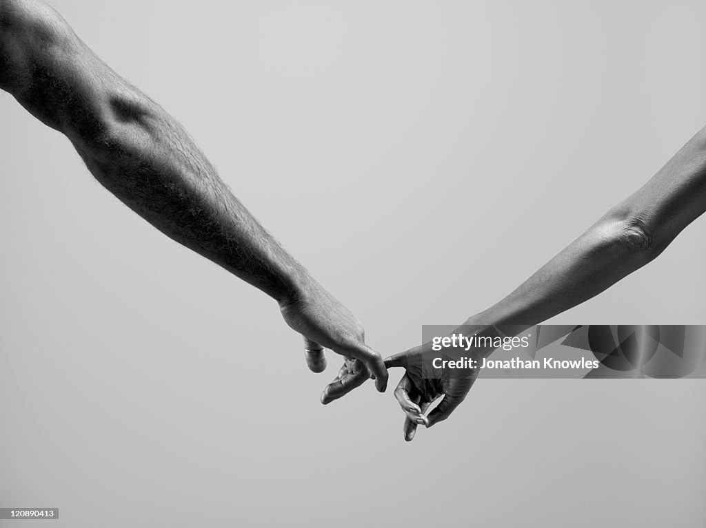 Female and male connecting by fingers
