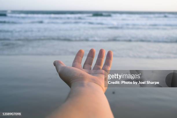 hand reaching out towards horizon - hand palm stock pictures, royalty-free photos & images