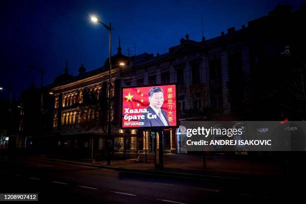 Picture taken on March 30 shows a billboard bearing Chinese President Xi Jinping's face looking down over a boulevard next to the words "Thank you...