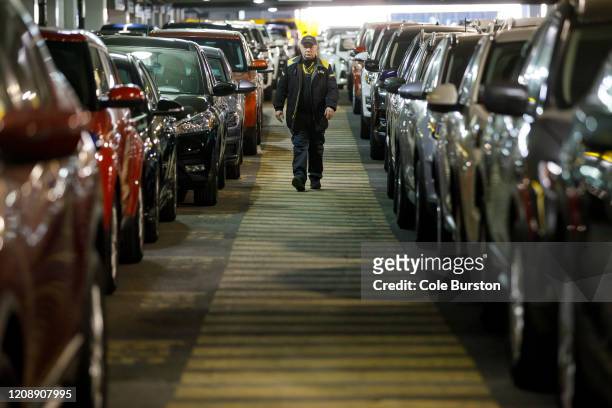 Hertz Car Rental employee walks between rows of unused rental cars at Toronto Pearson International Airport on April 1, 2020 in Toronto, Canada. Air...