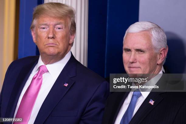 President Donald Trump looks on after a news conference with Vice President Mike Pence in the Brady Press Briefing Room at the White House February...