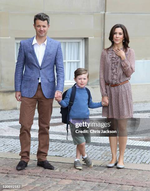 Crown Prince Frederik of Denmark and Crown Princess Mary of Denmark pose for photographs with their son Prince Christian of Denmark on his first day...