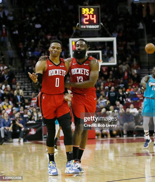 Russell Westbrook of the Houston Rockets is calmed down by James Harden after a technical foul was called on him during the second quarter against...