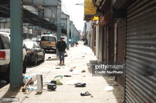 An elderly man walks down a trash-strewn street in Philadelphia, PA, on April 1, 2020.