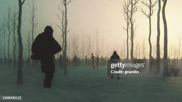 zombie-apokalypse überlebende im winterwald - zombies stock-fotos und bilder